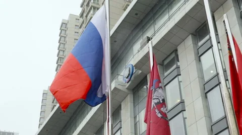 Three Flags Fluttering in the Wind Under Rain Against the Background of the Stock Footage 64621643