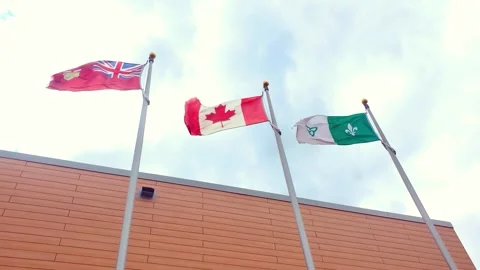 Three flags representing Ontario, Canada, and Franco-Ontarian communities Stock Footage 321570666