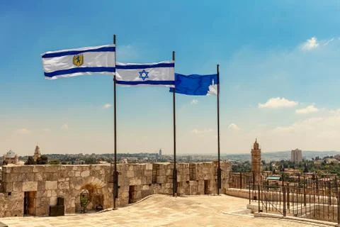 Three flags waiving on top of the citadel walls in Jerusalem. Stock Photos