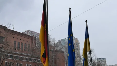 Three flags waving on poles - EU, DE and UA Stock Footage 100652883