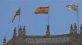 Three flags waving on top of Bank of Spain in Barcelona 4k or 4k+ Resolution
