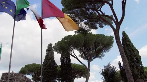 Three flags waving in wind against blue sky. Close up of Italian, EU and flag of Stock Footage 130731589