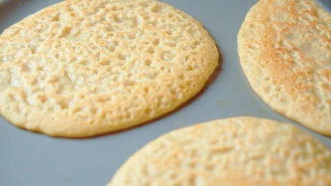 Three flapjack, tortilla, pancakes, bake in fry pan. Cooking shovel. Close up. Stock Footage 128701455