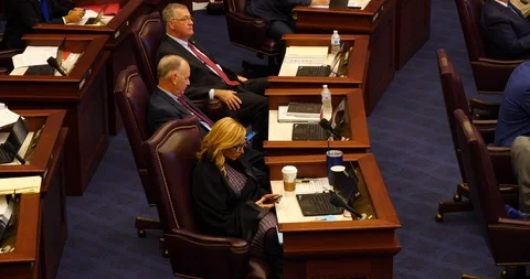 Three Florida state senators sit at desk during floor debate 2019 Stock Footage 107572891