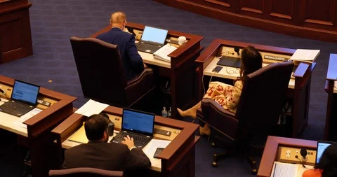 Three Florida State senators working at desks during debate. 2019 session Stock Footage 107598280