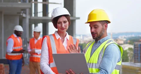 Three foremen witn tablet and female architect standing in the construction site Stock Footage 172287529