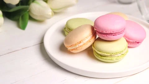 Three french macaroons on a white plate Stock Footage 154631295
