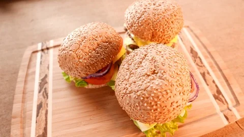 Three fresh appetizing hamburgers with a salad and tomato 動画素材 74169070