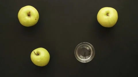 Three fresh apples is Squeezed Into a Glass. Stop Motion Animation Stock Footage 87831536