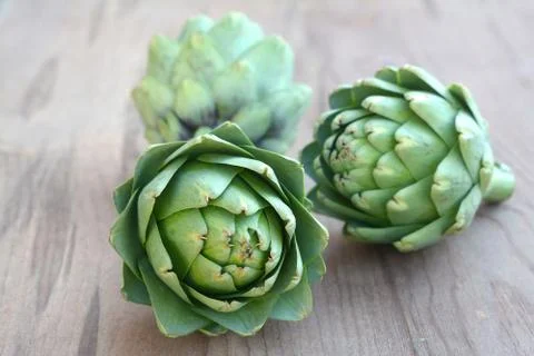 Three fresh artichokes Stock Photos