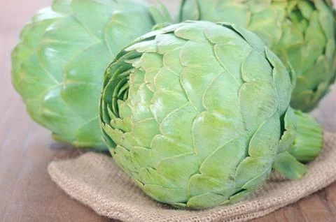 Three fresh artichokes Stock Photos