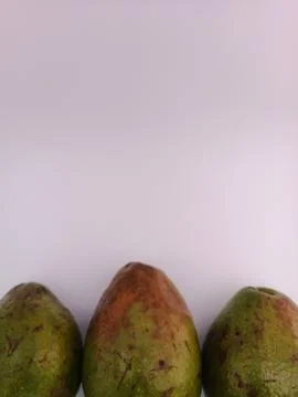 Three fresh avocado in a white background Stock Photos