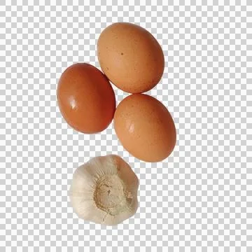 Three fresh brown chicken eggs and one head of garlic bulb for cooking deli.. Фото