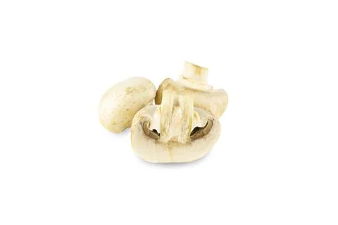 Three fresh champignons, one is cutted lengthwise, isolated on white Stock Photos