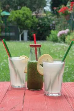 Three fresh drinks, a fruit and vegetable smoothy and two lemonades Stock Photos