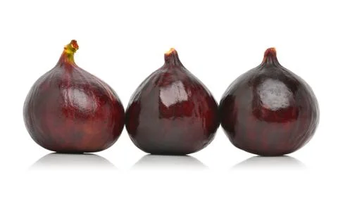 Three fresh figs isolated on the white Stock Photos