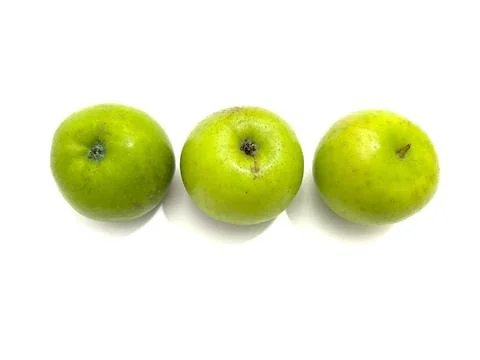 Three fresh green apples with smooth skin Stock Photos