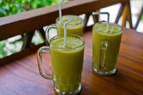 Three fresh mango milkshakes Stock Photos