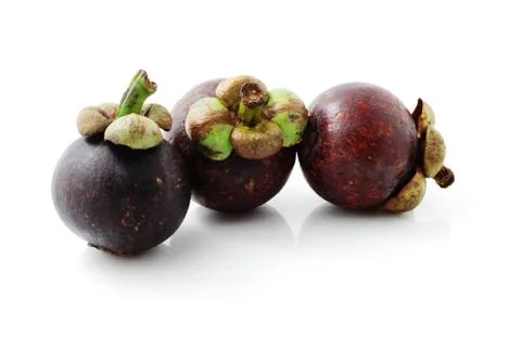 Three fresh mangosteens Stock Photos