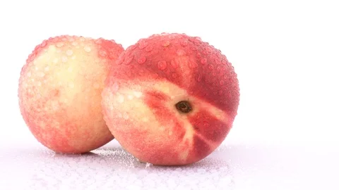 Three fresh nectarines with water drops rotating on a turn table. Stock Footage 88631416