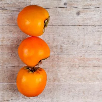 Three fresh persimmons Stock Photos