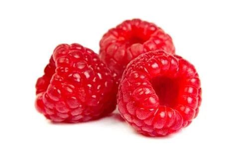 Three fresh raspberry on a white background. Close up macro shot Stock Photos
