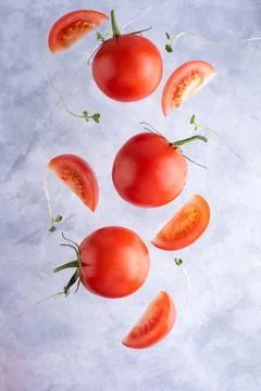 Three fresh red tomatoes with micro grins on a gray background, top view, clo Foto stock