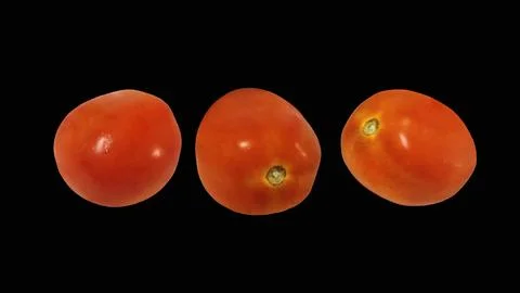 Three fresh ripe red tomatoes isolated on black background. Stock Photos