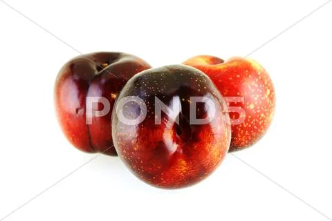 Three fresh ripe sweet plums Stock Photos