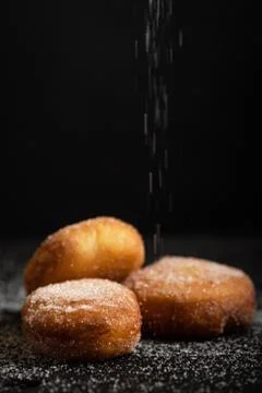 Three freshly made eclair in a black background Stock Photos