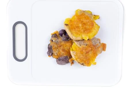 Three fried smashed multicolored potatoes on a cutting board top down Stock Photos