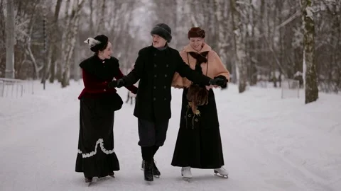 Three friends are skating, holding each other's hands.   Stock Footage 301296489
