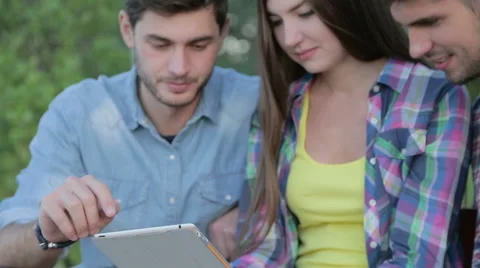 Three friends are watching at the tablet Stock Footage 56439664