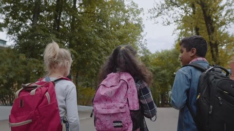 Three Friends With Backpacks Are Going to School. Back View of Mixed Racial Video stock 112669819