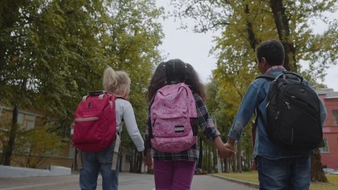 Three Friends With Backpacks Are Going to School. Back View of Mixed Racial Video stock 112670008