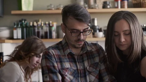 Three friends is cooking a dish with flour on their faces and laugh Stock Footage 73576595