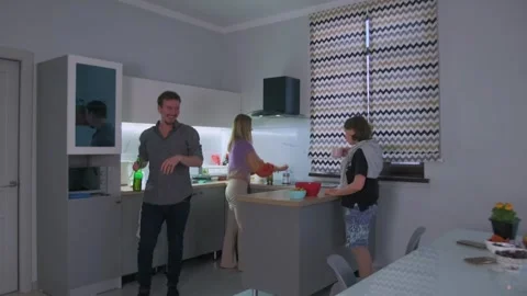Three friends dance and laugh cooking together, four friends enjoying dance and Stock Footage 323856146