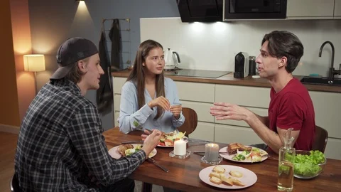Three friends having dinner and talking Stock Footage 114809811