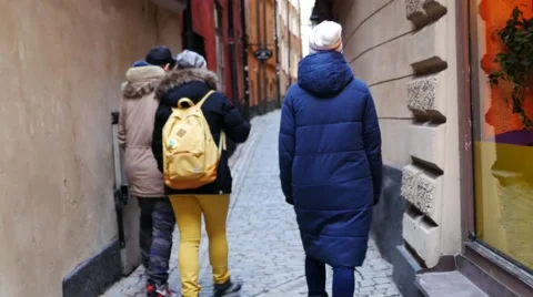 Three friends having a walk along the old narrow street in Stockholm Vídeos de archivo 61544558