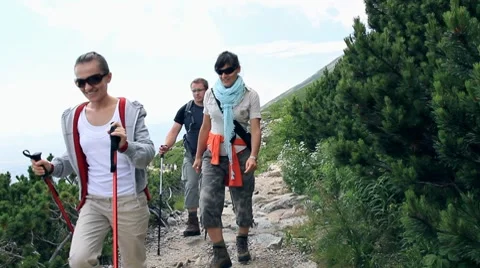 Three friends hiking in the mountains Stock Footage