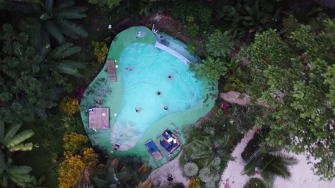 Three friends jumping into the pool Stock Footage 166561362