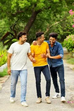 Three Friends Laughing Together While Having Fun In The Park Stock Photos