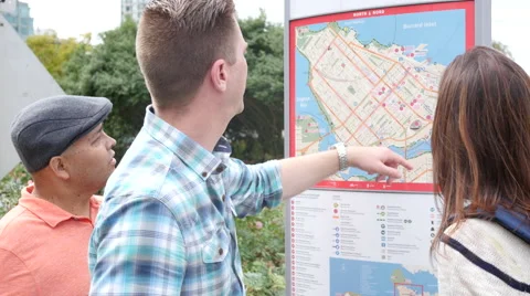 Three friends looking at map Stock-Footage 67353069
