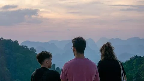 Three friends looking at the mountain during a vibrant sunset from Tiger Ca.. Stock Photos
