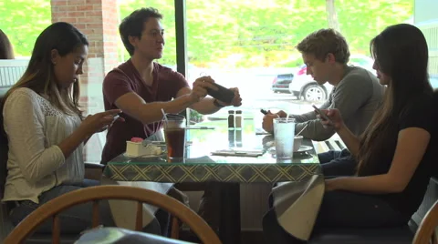 Three friends looking at their cell phones, ignore the fourth. Stock Footage 44116412
