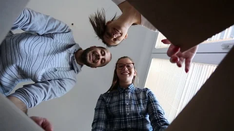Three friends open cardboard box Stock Footage 81704478