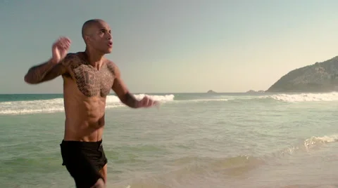 Three friends playing football on Ipanema beach Stock Footage 59377285