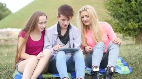 Three friends playing game on tablet pc. They winning again. Stock Footage 53484599