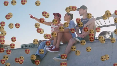 Three friends pointing off-screen at skatepark starting emoji swarm showing Stock Footage 329775795