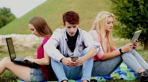 Three friends relaxing and having fun in park. Video stock 55233302
